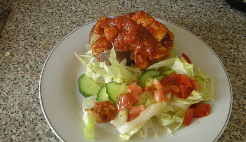 Turkey in Tomato Sauce served over Jacket Potato