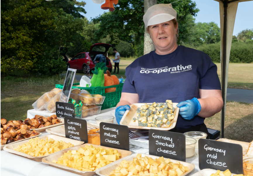 A CI Co-op colleague shows off the cheeses on offer at Le Viaer Marchi