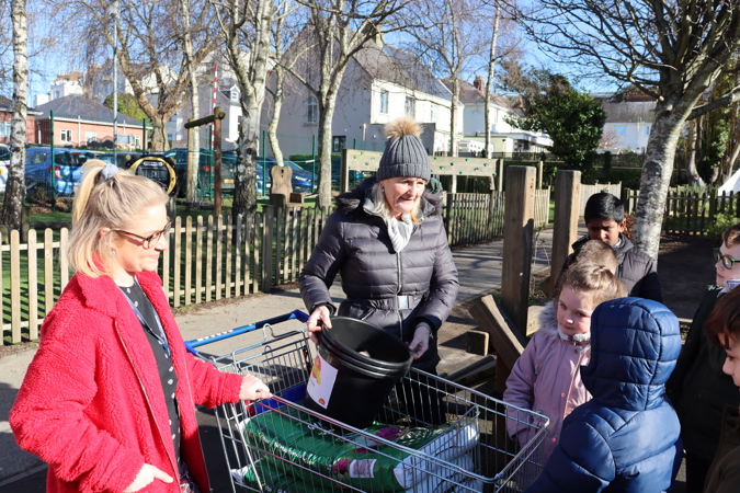 Emily, from the Co-op, gives the pupils their potatoes