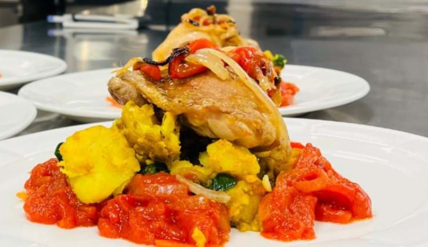 Highlands College's Saag aloo, new potatoes and oven-roast chicken thighs with a tomato & red pepper sauce