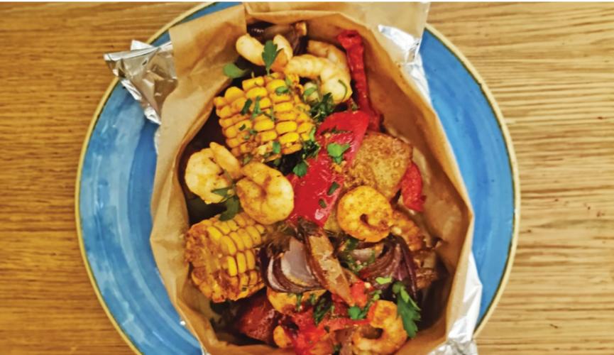 Spicy potato and sausage parcels with peppers and red onion