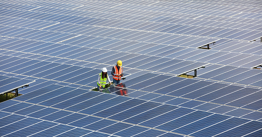 technicians work on a solar panel array